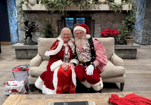 An older couple dressed for Christmas pose on a couch with garland and a coffee-table book titled &ldquo;American Cowboy.&rdquo;